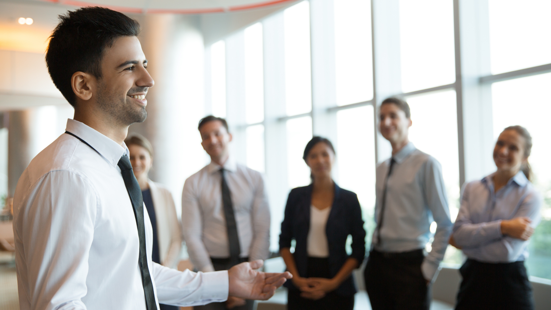 Colleagues smiling and talking in an office