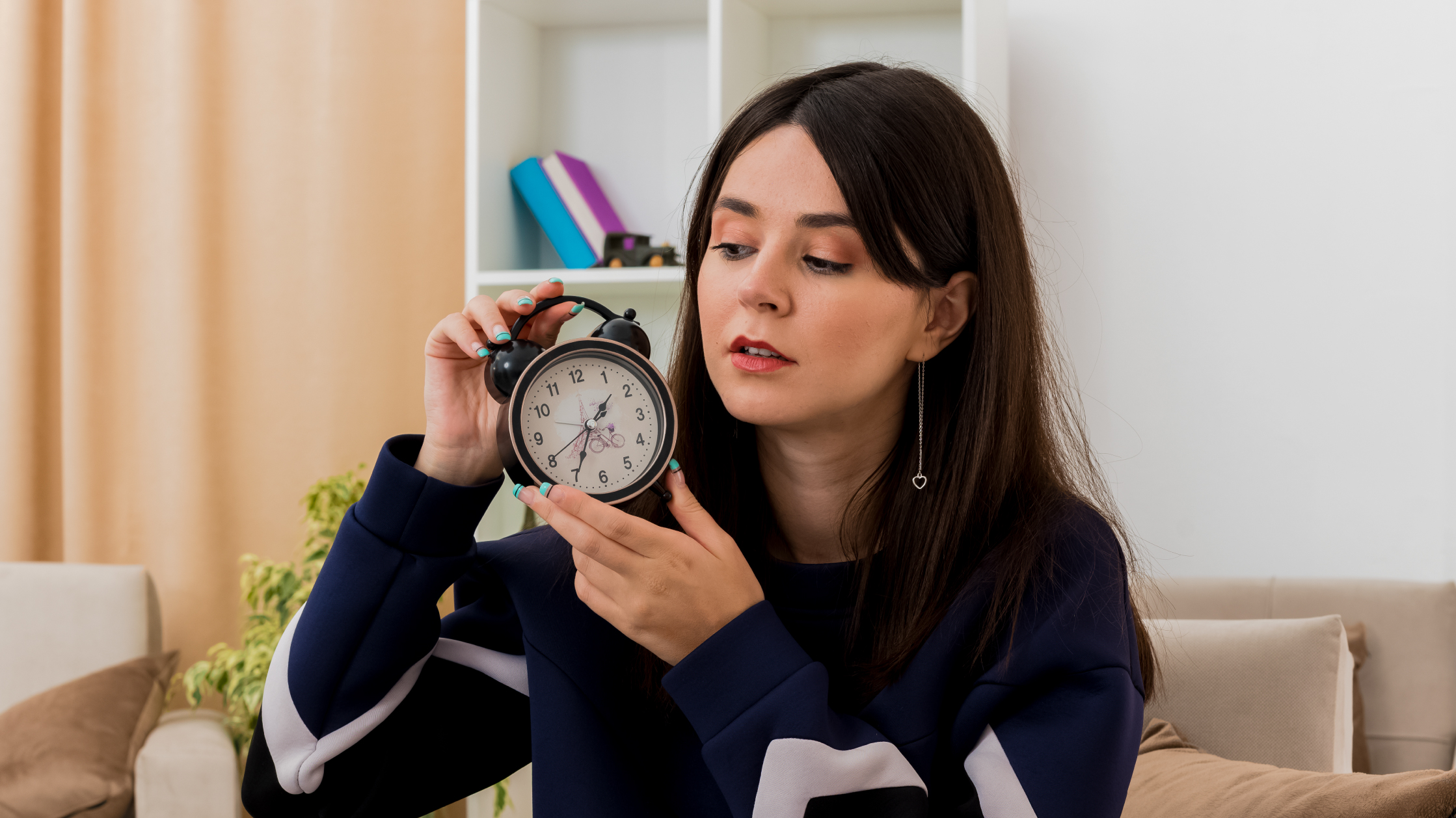 woman holding an alarm clock